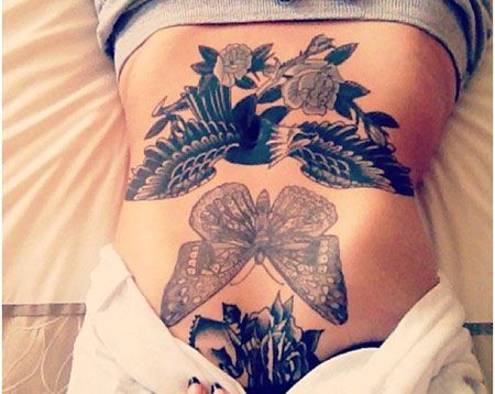 Belly tattoo with butterfly and wings