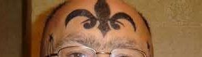 Forehead tattoo with black symbol