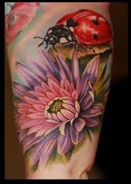 Flower and ladybug tattoo