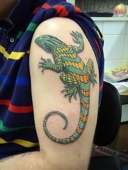 Green and yellow lizard tattoo
