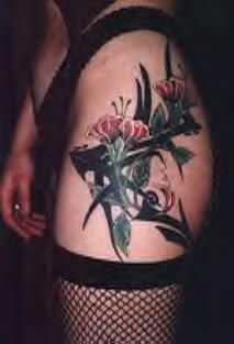 Hip tattoo with flowers and tribal