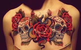 Skulls among roses chest tattoo