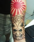 Arm tattoo with devil and sun