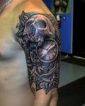 Arm tattoo with skull and clock