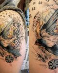 Arm tattoo with swallow