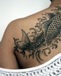 Black fish tattoo on back