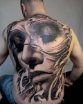 Face tattoo on back