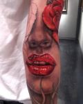 Face with red lips tattoo
