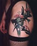 Hip tattoo with flowers and tribal