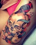 Bird and skull tattoo on leg