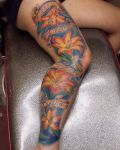 Big tattoo with flowers on leg