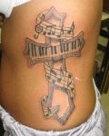Music cross belly tattoo