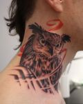 Owl tattoo on the neck