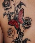 Red butterfly and flowers tattoo