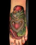 Red heart and bird tattoo