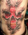 Red skull belly tattoo