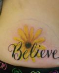 Yellow daisy with word "belive"