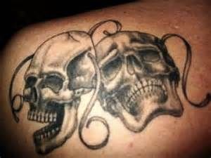 Two skulls mask tattoo