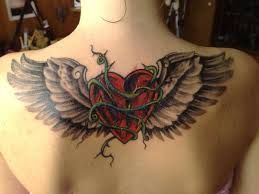 Wings and red heart tattoo