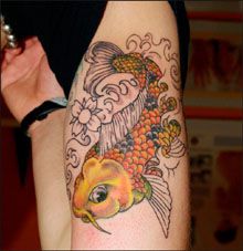 Yellow fish arm tattoo